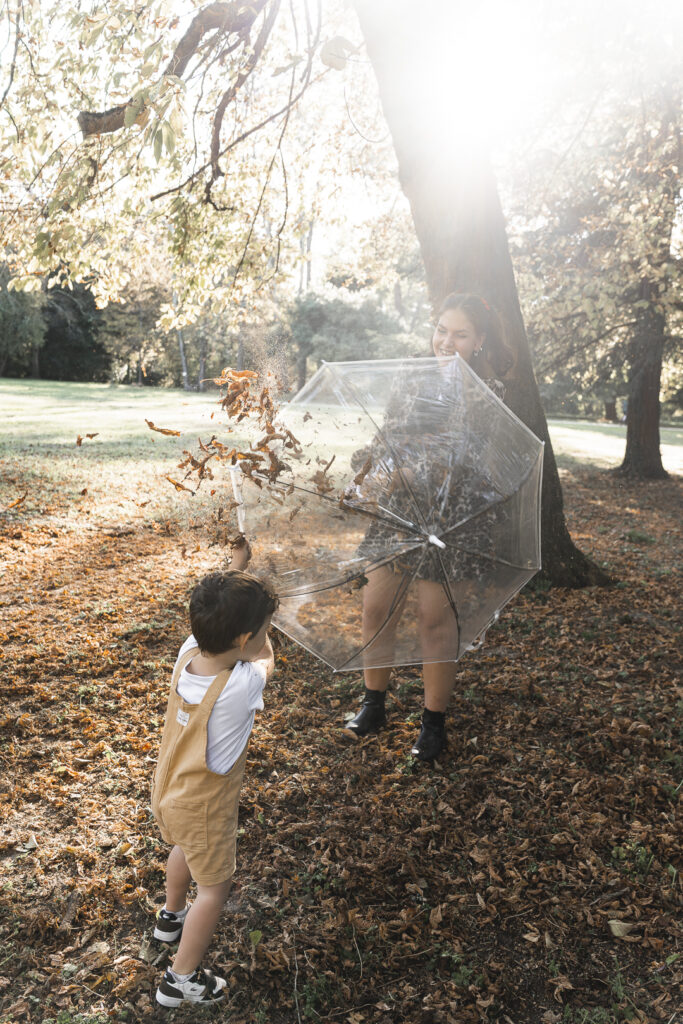 Tante et son neveu qui se se battent avec des feuilles pendant un shooting photo famille en extérieur au parc majolan de blanquefort en automne